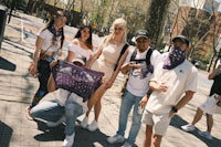 a group of people posing for a photo with a purple bandana