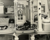 a black and white photo of a barbie doll house