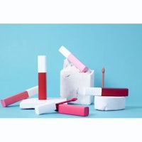 a collection of lipsticks and lip balms on a blue background