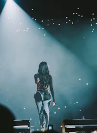 a woman standing on stage at a concert