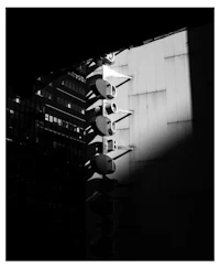 a black and white photo of a street light pole