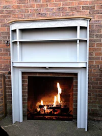 a fireplace mantle with a fire burning in it