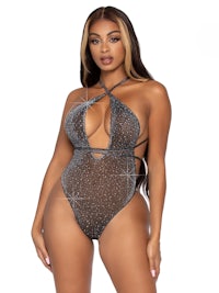 a woman in a silver bodysuit with a halter neck