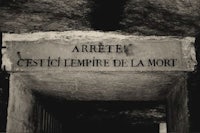 a black and white photo of a sign in a tunnel