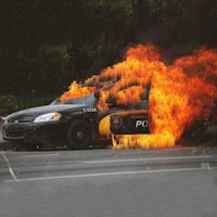 a police car with flames coming out of it