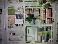 an aerial view of a street and houses
