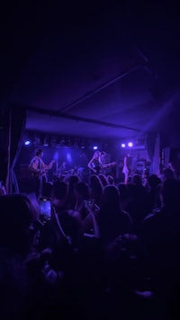 a group of people on stage in a dark room
