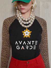 a woman wearing a leopard print top and a hat