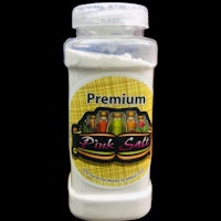 a jar of premium pink salt on a black background