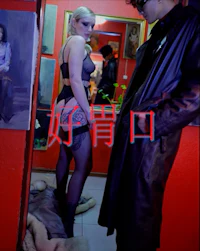 a man and woman standing in front of a mirror