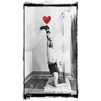 a black and white photo of a woman doing a handstand