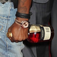 a man holding a bottle of liquor