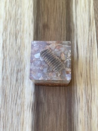 a small piece of soap sitting on top of a wooden table