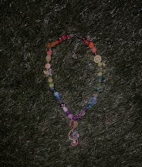 a colorful necklace laying on the grass