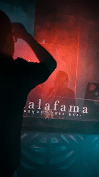 a man standing in front of a bar