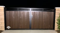 a wooden gate with a black and brown finish