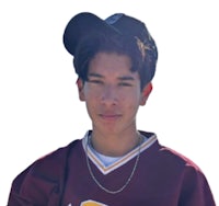 a young man in a baseball uniform posing for a photo
