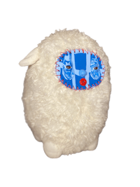 a white stuffed animal with a blue eye on it