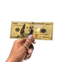 a person holding a gold one hundred dollar bill