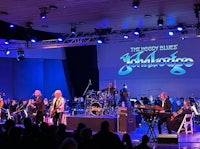 a group of musicians on stage at a concert