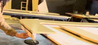 a woman is working on a table in a workshop