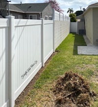 a white vinyl fence in a backyard