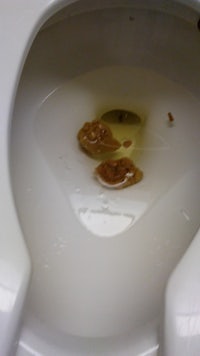 a toilet with a piece of food in it