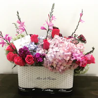 a bouquet of flowers in a polka dot box