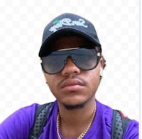 a man wearing sunglasses and a purple shirt