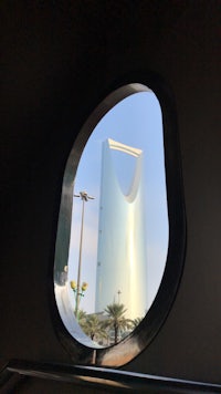 a view of the saudi arabia tower through a window