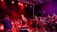 a group of musicians on stage at a concert