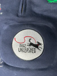the back of a blue jacket with a dog logo on it