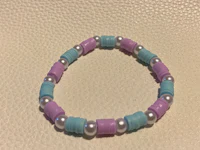 a bracelet with blue and purple beads and pearls