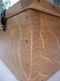 a wooden box with rivets on it
