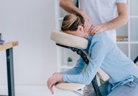 a woman getting a massage in a massage chair
