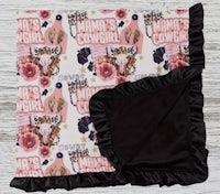 a baby blanket with ruffles and flowers on it