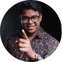 a man in glasses is pointing his finger at the camera