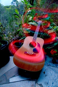 an acoustic guitar on the ground