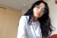 a girl wearing glasses and a shirt with hearts on it