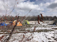 a group of tents in a field covered in snow