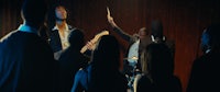a group of people playing music in a dark room