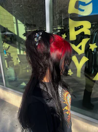 a woman with red hair in front of a store