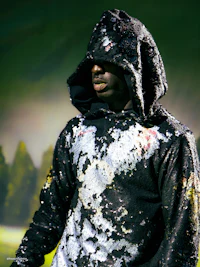 a man in a black hoodie holding a frisbee
