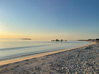 a view of a beach with a boat in the water