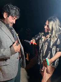 a man is talking to a woman at an event
