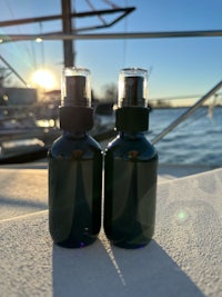 two bottles sitting on top of a boat in the water
