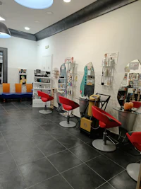 a hair salon with many chairs and tables