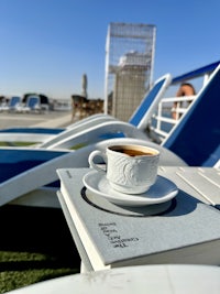 a cup of coffee sits on top of a book