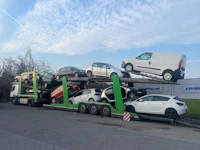a flatbed truck with several cars on it