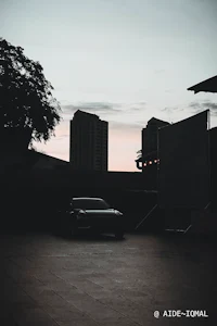 a car parked in a parking lot at dusk
